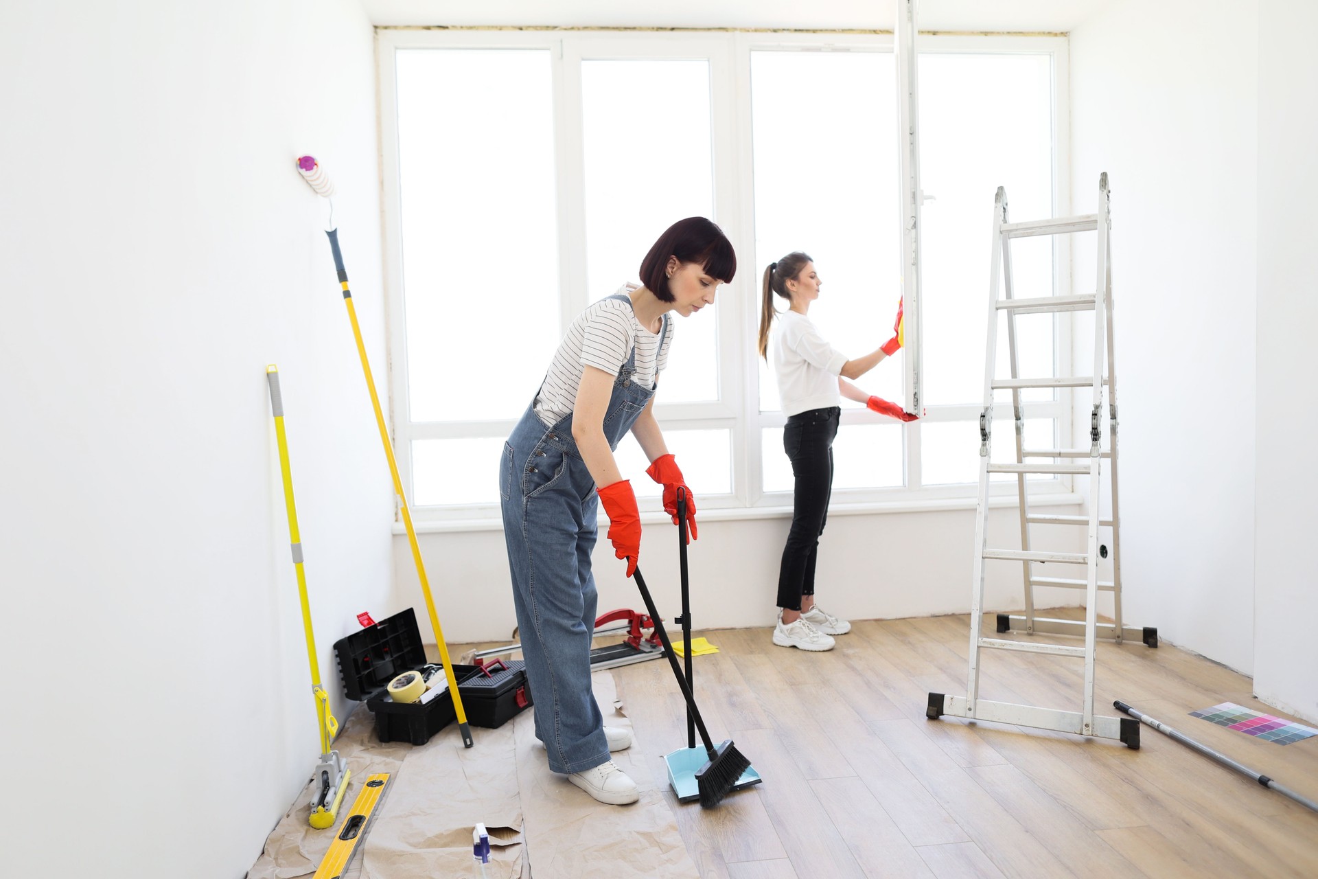 Young beautiful women cleaning up new apartment after renovation.